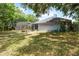 Spacious backyard featuring a screened-in pool and lush trees surrounding the property at 1689 Saboff Way, Chuluota, FL 32766
