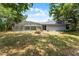 Backyard featuring a screened-in pool and lush trees surrounding the property at 1689 Saboff Way, Chuluota, FL 32766