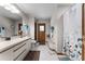 Well-lit bathroom with a shower/tub combination, built in bench, and white vanity at 1689 Saboff Way, Chuluota, FL 32766