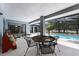 Covered patio with multiple seating options overlooking a screened-in pool and backyard at 1689 Saboff Way, Chuluota, FL 32766