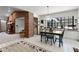 Dining area with large windows, stylish light fixture and brick accent wall at 1689 Saboff Way, Chuluota, FL 32766