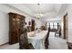 Formal dining room with a chandelier, carpeted floors, and an antique china cabinet at 1689 Saboff Way, Chuluota, FL 32766