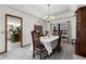 Carpeted formal dining room featuring a chandelier, and a window view to the outside at 1689 Saboff Way, Chuluota, FL 32766
