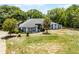 Beautiful single-story home featuring mature trees and lush landscaping, plus a bright red front door at 1689 Saboff Way, Chuluota, FL 32766