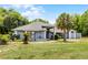 Inviting one-story home featuring lush green lawn, mature landscaping, and a side entry garage at 1689 Saboff Way, Chuluota, FL 32766
