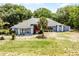 Inviting home with lush landscaping, mature trees, and a welcoming red front door at 1689 Saboff Way, Chuluota, FL 32766