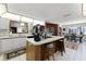 Kitchen with island, butcher block accents, white cabinets, and a view into the dining area at 1689 Saboff Way, Chuluota, FL 32766