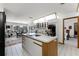 Open kitchen with butcher block island, stainless appliances, and an adjacent dining area at 1689 Saboff Way, Chuluota, FL 32766