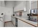 Kitchen with white cabinets, long counters and a stainless steel sink at 1689 Saboff Way, Chuluota, FL 32766