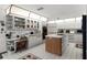 Bright kitchen with custom lighting, white cabinets, and a butcher block island cooktop at 1689 Saboff Way, Chuluota, FL 32766