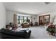 Living room with a large bay window, comfortable seating, and access to the sunroom at 1689 Saboff Way, Chuluota, FL 32766
