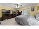 Comfortable bedroom with neutral carpet, ceiling fan, dresser set, and sliding glass door at 1689 Saboff Way, Chuluota, FL 32766