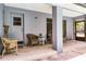 Covered patio with cushioned wicker chairs, a small table, and access to the screened-in pool area at 1689 Saboff Way, Chuluota, FL 32766