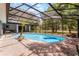 Backyard pool with screened enclosure and mature trees at 1689 Saboff Way, Chuluota, FL 32766