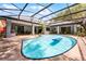 Aerial view of screened pool, mature trees, covered patio, and backyard at 1689 Saboff Way, Chuluota, FL 32766