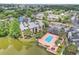 Aerial view of the complex, showcasing lush landscaping, a community pool, and a lake at 1908 Lake Atriums Cir # 3, Orlando, FL 32839