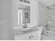 Modern bathroom with vanity, a large mirror, and a shower with elegant marble tile at 1908 Lake Atriums Cir # 3, Orlando, FL 32839