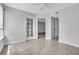 Bright bedroom with wood-look tiled floors and a doorway leading to another room at 1908 Lake Atriums Cir # 3, Orlando, FL 32839