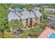 Exterior of building overlooking a pool and serene lake, surrounded by lush palm trees at 1908 Lake Atriums Cir # 3, Orlando, FL 32839
