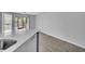 Open-concept kitchen with white countertops, stainless steel sink, and wood-look tile flooring at 1908 Lake Atriums Cir # 3, Orlando, FL 32839