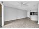 Bright and airy living room with wood-look tile flooring and a ceiling fan at 1908 Lake Atriums Cir # 3, Orlando, FL 32839