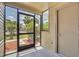 An exterior screen door with outside views of the community and a nearby pool at 1908 Lake Atriums Cir # 3, Orlando, FL 32839