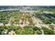 Wide aerial view of a lush, green neighborhood near a lake and city skyline at 2114 Gerda Ter, Orlando, FL 32804