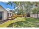 Well-manicured backyard with large wooden fence, deck, and a patio area perfect for outdoor dining at 2114 Gerda Ter, Orlando, FL 32804