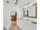 Bright bathroom with white cabinets, a large mirror, and access to the bedroom at 2114 Gerda Ter, Orlando, FL 32804