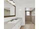 Bright bathroom with white cabinets, a large mirror, and a separate walk-in shower at 2114 Gerda Ter, Orlando, FL 32804