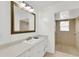 Bright bathroom with white cabinets, a large mirror, and a separate walk-in shower at 2114 Gerda Ter, Orlando, FL 32804
