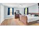 Bedroom featuring hardwood floors, a ceiling fan, and bright windows with dark curtains at 2114 Gerda Ter, Orlando, FL 32804