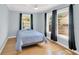 Well-lit bedroom with a large window and classic hardwood floors at 2114 Gerda Ter, Orlando, FL 32804