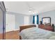 Bedroom featuring hardwood floors, a ceiling fan, and bright windows with dark curtains at 2114 Gerda Ter, Orlando, FL 32804