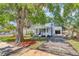 Charming home with a brick driveway, lush lawn, and mature trees at 2114 Gerda Ter, Orlando, FL 32804