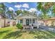 Cozy home with a charming front porch, beautiful landscaping, and a brick-paved driveway at 2114 Gerda Ter, Orlando, FL 32804