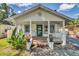 A quaint porch with brick steps and vibrant potted flowers frames the entrance of a charming home at 2114 Gerda Ter, Orlando, FL 32804