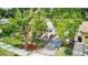 Home with lush trees, paved driveway, manicured front lawn, and inviting front porch at 2114 Gerda Ter, Orlando, FL 32804