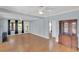 Bright living room featuring hardwood floors, large windows, and a vintage hutch at 2114 Gerda Ter, Orlando, FL 32804