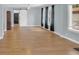 Light and bright living room with wood floors, a ceiling fan, and a sliding barn door at 2114 Gerda Ter, Orlando, FL 32804
