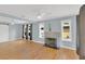 A spacious living room featuring hardwood floors, a gray fireplace, and large windows for lots of natural light at 2114 Gerda Ter, Orlando, FL 32804