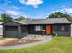 Charming home with a paved driveway and inviting front yard with modern landscaping at 2121 Vivada St, Orlando, FL 32803