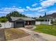Home exterior features a paved driveway, charming walkway, and well-kept lawn at 2121 Vivada St, Orlando, FL 32803