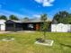 Charming home with well-manicured lawn, dark exterior, and bright orange front door at 2121 Vivada St, Orlando, FL 32803