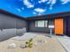 Charming entryway features a bright orange door and low-maintenance landscaping at 2121 Vivada St, Orlando, FL 32803