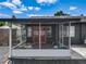 View of the screened patio with red french doors and a backyard at 2121 Vivada St, Orlando, FL 32803