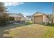 Well-maintained backyard featuring a covered patio, detached garage, and lush lawn, ideal for outdoor activities at 2314 Falkner Rd, Orlando, FL 32810