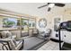 Enclosed lanai with tile flooring, comfortable seating, treadmill, and view of the street, inviting year-round enjoyment at 2314 Falkner Rd, Orlando, FL 32810