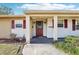 Inviting front porch with classic design details and a pop of color from the front door at 2314 Falkner Rd, Orlando, FL 32810