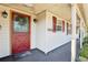 Inviting front porch with classic design details and a pop of color from the front door at 2314 Falkner Rd, Orlando, FL 32810
